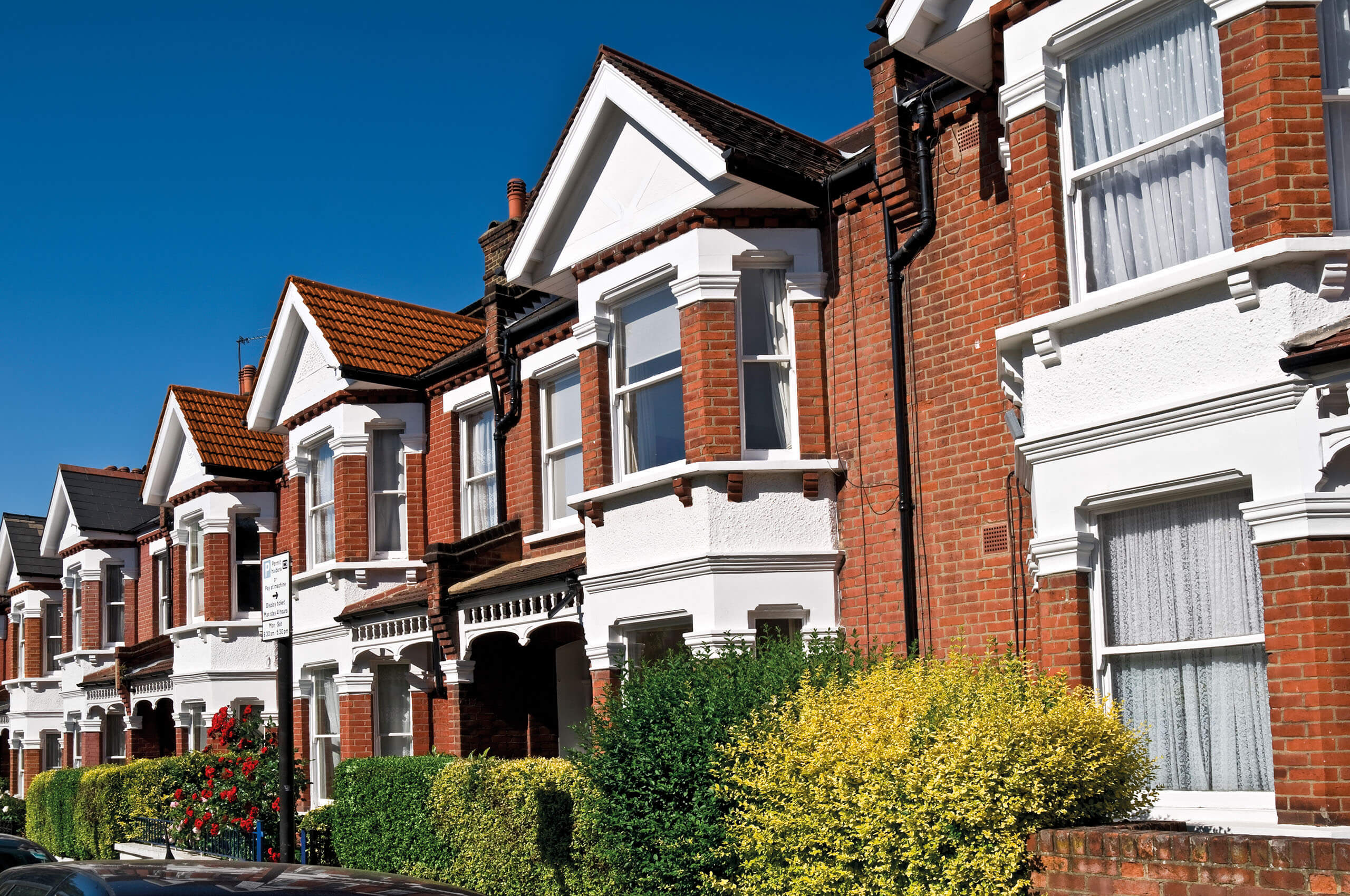 A row of Edwardian terraced houses in the sunshine