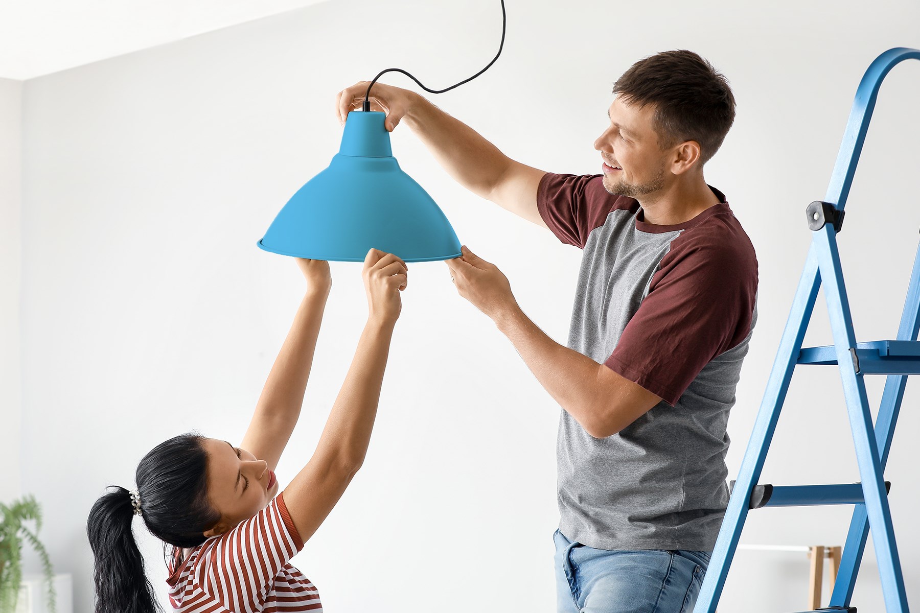 Man and a woman fitting a lampshade