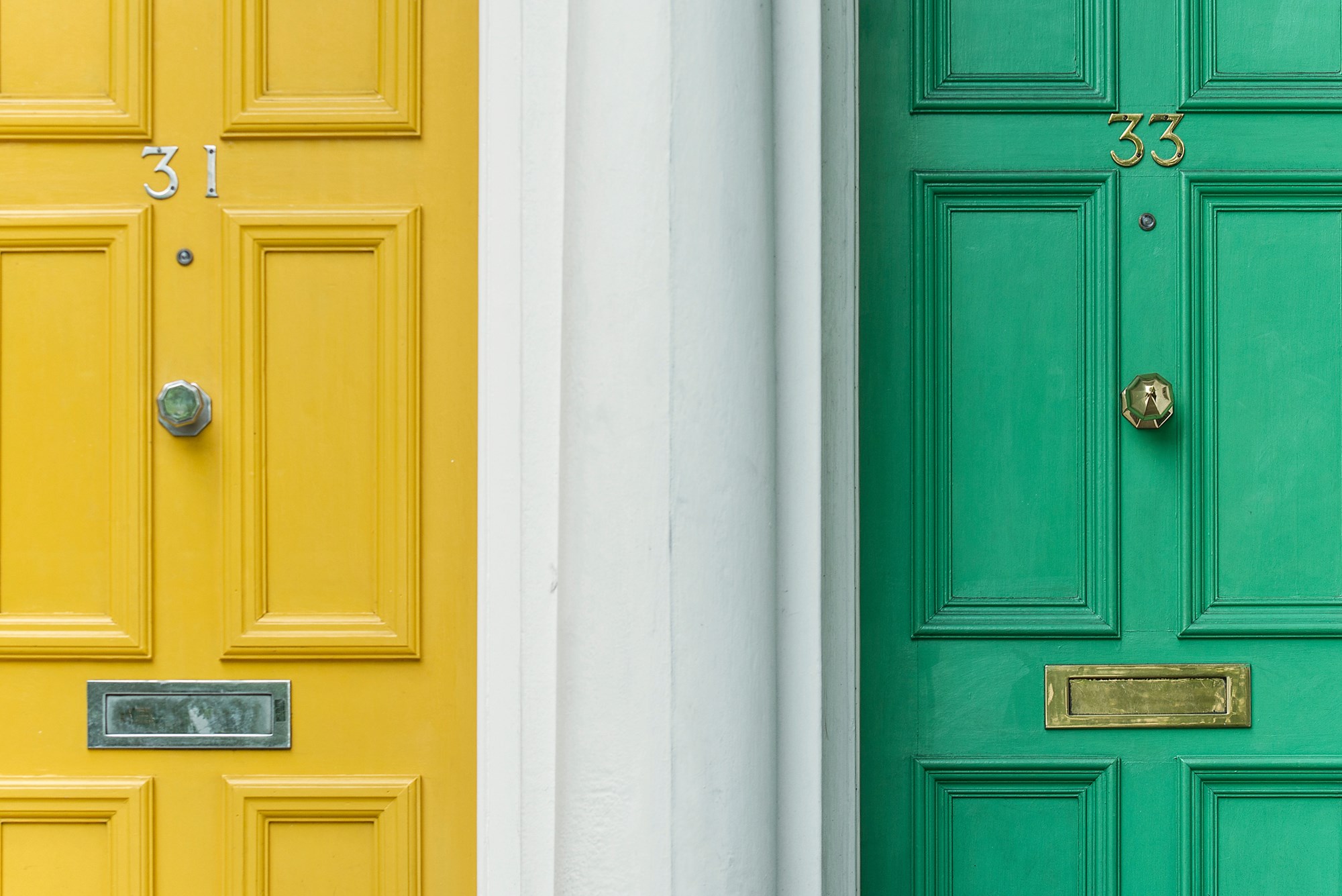 A yellow front door and a green front door