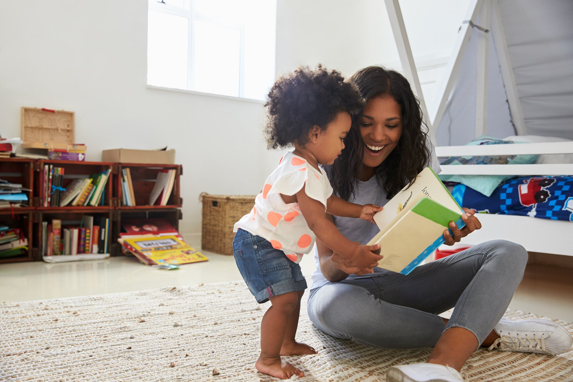 Woman with young child reading a book